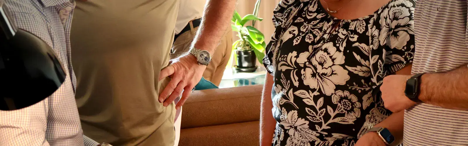 Customers and tailors looking through fabric swatch books together during a consultation